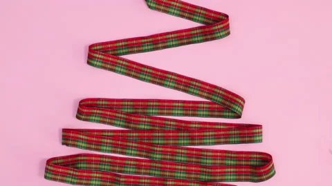 Making Christmas tree shape with plaid ribbon on pink theme. Stop motion Stock Footage 162005258