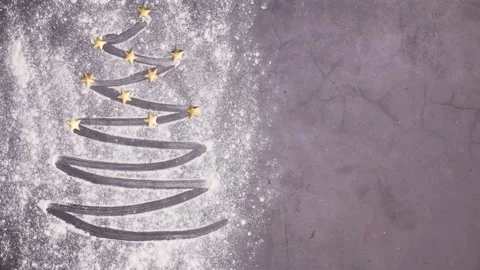Making Christmas tree with stars with baking flour. Stop motion Stock Footage 144399803