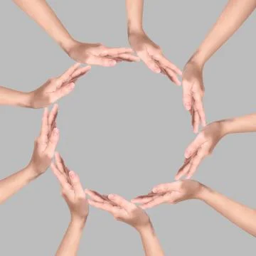 Making circle of human hands on grey background. Unity, partnership, cooper.. Stock Photos