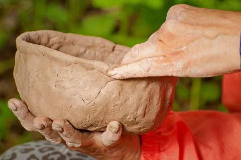 Making clay dishes manually. Big hands. On the street Stock Photos