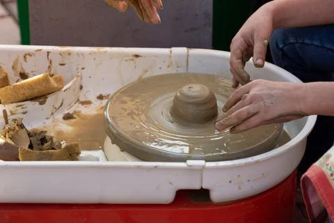 Making A Clay Pot. Potter working on potters wheel making ceramic pot from .. Stock Photos