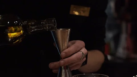 Making a cocktail, adding alcohol into glass Video stock 124032163