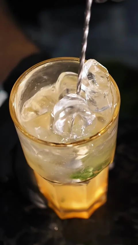 Making a cocktail. close-up. The bartender mixes all the ingredients and ice Stock Footage 316781638