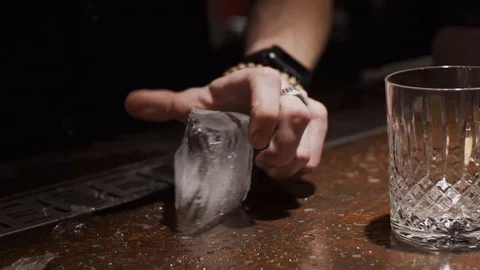 Making a cocktail, cutting big chunk of ice Stock Footage 124032203