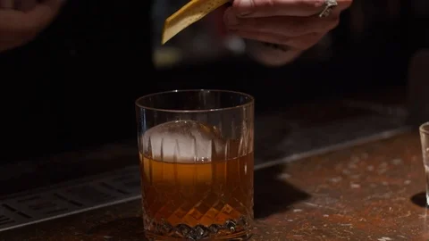 Making a cocktail, decorating with orange peel Stock Footage 124032225