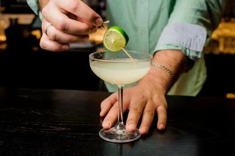 Making the cocktail with lime close up Photos