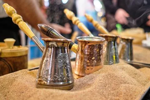 Making coffee according to the Turkish method of Turk in the sand. Stock Photos