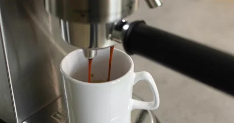 Making coffee by coffee machine into cup, espresso coffee coming out from an Stock Footage 196728851