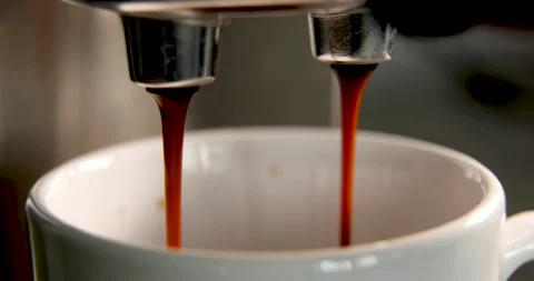 Making coffee by coffee machine into cup, espresso coffee coming out from an Stock Footage 196729277