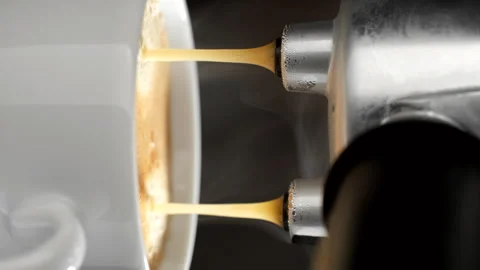 Making coffee by coffee machine in cup, espresso coffee pouring in cup Stockbeeldmateriaal 248126029
