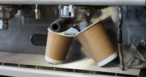 Making coffee by coffee machine into cups, espresso coffee coming out from an Stock Footage 237222948
