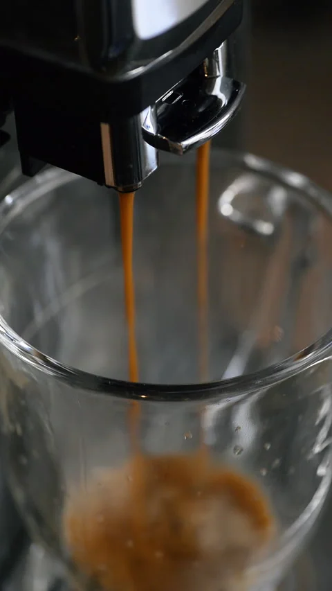 Making coffee in a coffee machine. Vertical video. Stock Footage 325704814