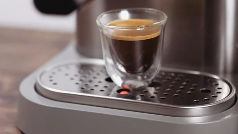 Making coffee. Cup of freshly brewed espresso with foam, crema. Stock Footage 112680312