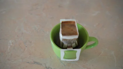 Making coffee with drip coffee bag. Drip brewing coffee. Stock-Footage 276237443