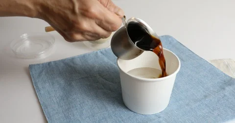 Making coffee ice with water, coffee and sugar in paper cup Stock Footage 110852884