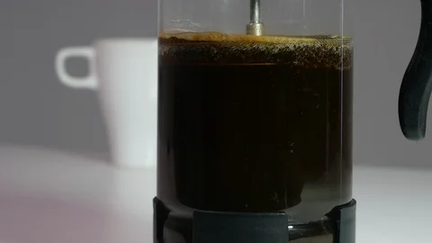 Making coffee, pushing down the plunger on a Cafetiere / French Press Stock Footage 104783791