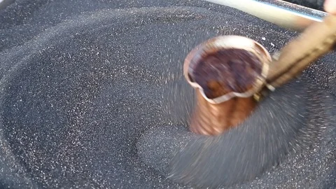 Making coffee in the sand Stock Footage 99821643