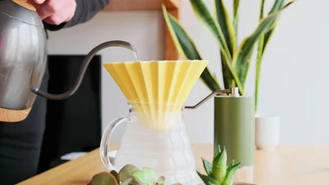 Making coffee. Speciality coffee at home. Barista pours water from the drip Stock Footage 153603757