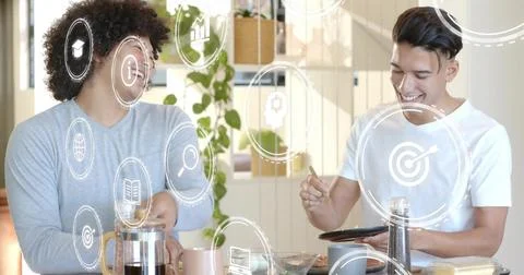 Making coffee two men wearing gray long-sleeve, white tee using tablet in Stock Photos