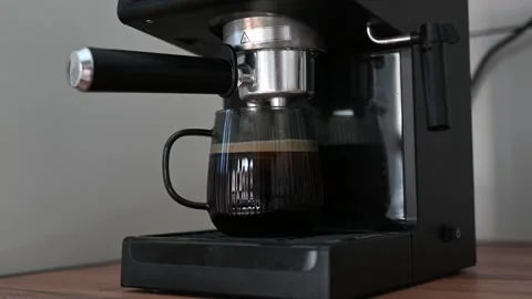 Making coffee using a modern espresso machine on a wooden table on a light Stock Footage 306466495