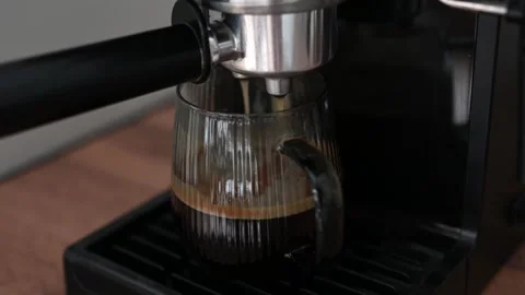 Making coffee using a modern espresso machine on a wooden table on a light Stock Footage 306939188