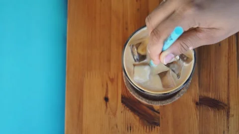 Making a cold coffee drink with ice and milk Stock Footage 342213426