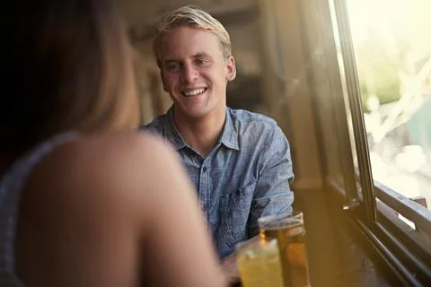 Making a connection. a young couple talking together in a bar. Stock Photos