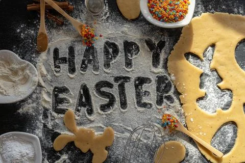 Making cookies for Easter. Writes the text Happy Easter. Bunny cut out of the Stock Photos