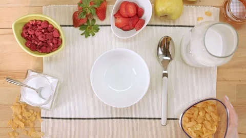 Making corn flakes at a breakfast table Video stock 100366335