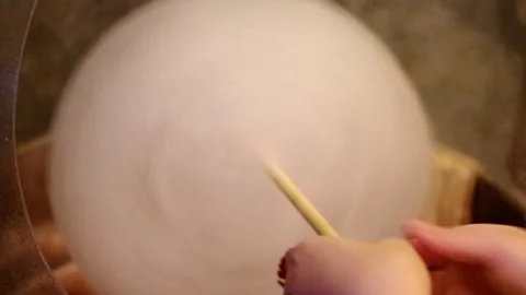 Making cotton candy adding sugar into candyfloss machine clip Stock Footage 248375490