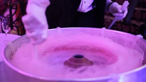 Making cotton candy in cotton candy maker Stock Footage 96177512