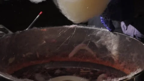 Making cotton candy or candy floss close-up. A spun sugar confection that Video stock 265911695