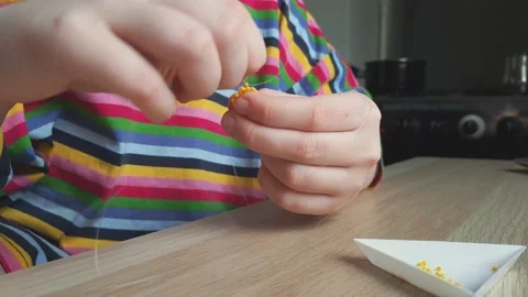 Making crafts from beads. Hands in action. Stock Footage 238936044