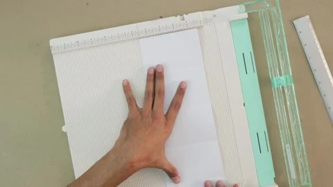 Making crafts. Scrapbooking tool to trim and score Stock Footage 168727700