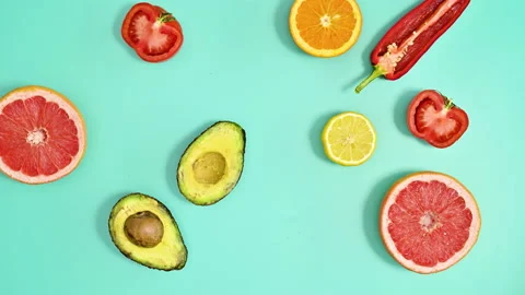 Making creative pattern with fresh ripe fruits on cyan background. Stop motion Stock Footage 192467635