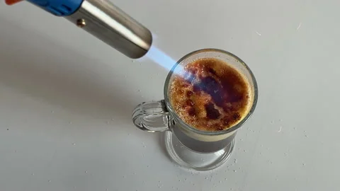 Making creme brulee with torch Stock Footage 189182879