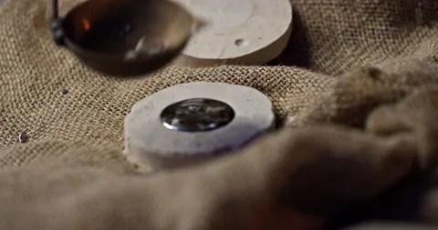 Making cryptocurrency from hot metal close up. An old vintage man pours molten Stock Footage 171473785