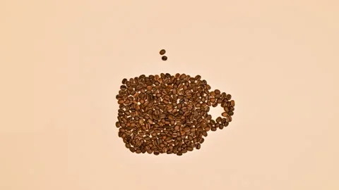 Making cup of coffee with coffee beans on pastel orange background. Stop motion Stock Footage 232151560