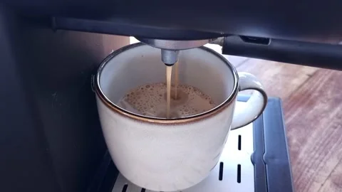 Making a cup of coffee in a coffee machine, close up. Stock Footage 221850057