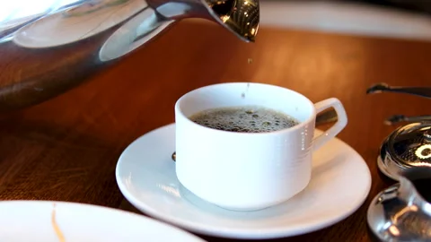 Making a cup of tea pouring hot boiling water over as tea bag Stock Footage 291956649