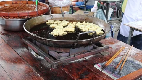 Making deep fried dough stick in metal pan and hot oil Video stock 140869336