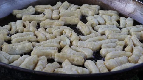 Making deep fried dough stick in metal pan and hot oil Video stock 141307239