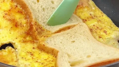 Making a delicious egg bread toast by folding an omelette over bread slices Stock Footage 324943380
