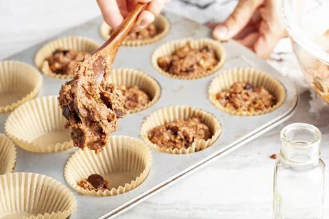 Making of delicious fruit and nut cupcake on white marble countertop backgrou Stock Photos