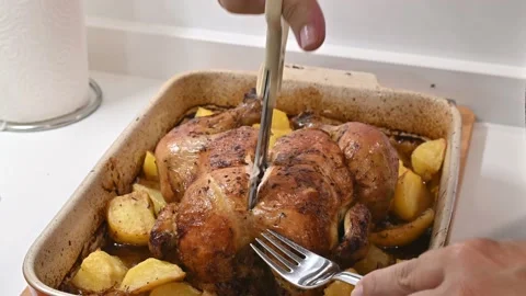 Making a delicious roast chicken. chopping it up Stock Footage 217984062