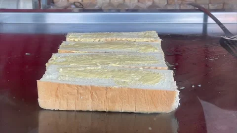 Making delicious toasted bread with butter on hot griddle Video stock 341897701