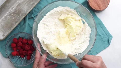 Making a dessert called Red Raspberry Tea Cake made with fresh berries and Stock Footage 313180352