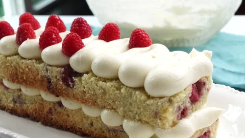 Making a dessert called Red Raspberry Tea Cake made with fresh berries and Stock Footage 313180359