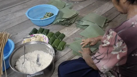 Making Dessert Khao Tom Mat. Steamed Sticky Rice Wrapped in Banana Leaves. Stock Footage 122432288