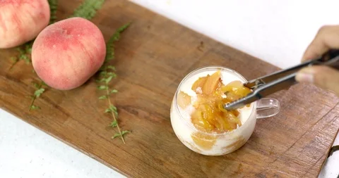 Making dessert with peach, plum compote and ice cream Stock Footage 113916266